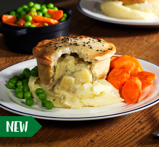 Table Table menu item of a vegan cheese and onion pie on a plate with peas and carrots.