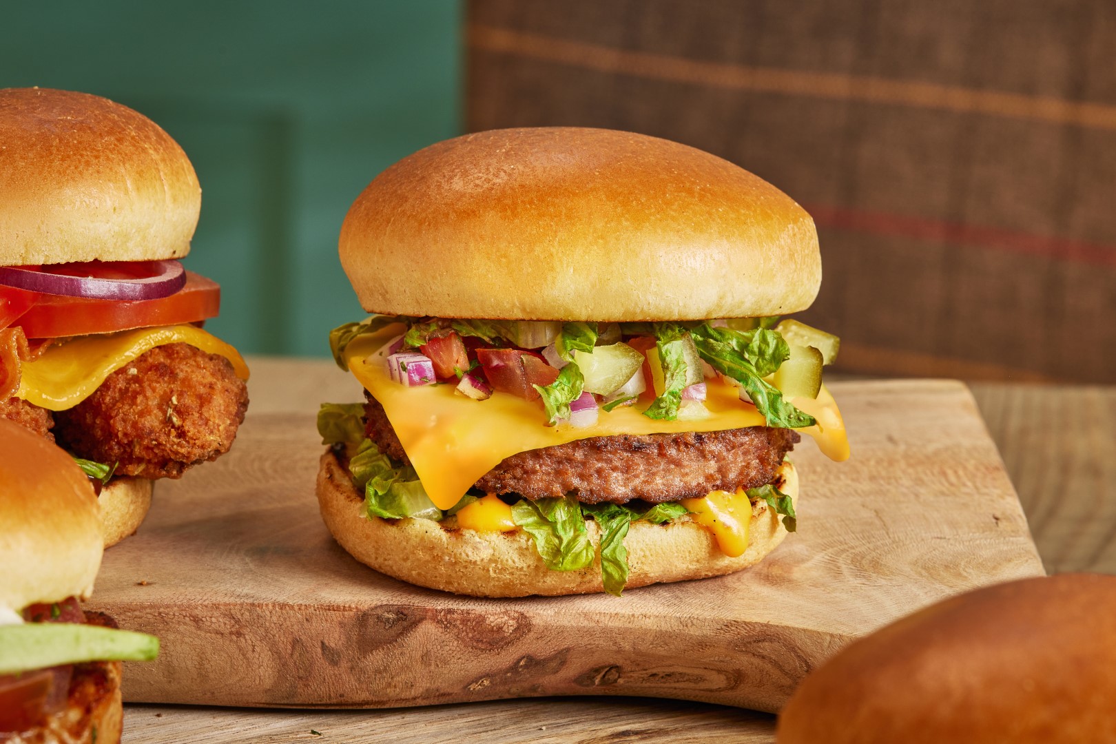 Table Table The Vegan Burger GARDEN GOURMET® Sensational™ burger with a Violife slice, lettuce, gherkin, red onion & burger sauce in a brioche style bun.